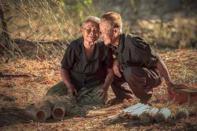 Senior couple sitting on field