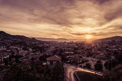 High angle shot of townscape against sky at sunset