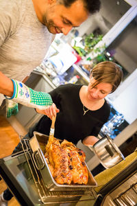 High angle view of people cooking food in kitchen