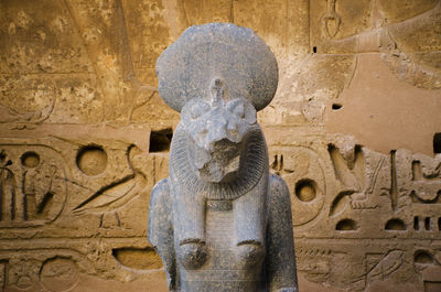 Close-up of statue against stone wall