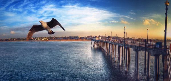 Pier on sea at sunset