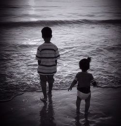 Full length of boy standing in water