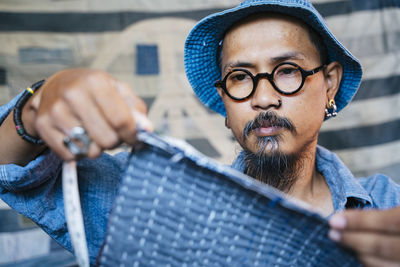 Man working over fabric on table