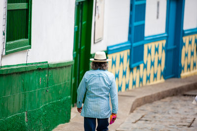 Local man wearing a traditional hat walking at the streets of concepcion in antioquia, colombia.