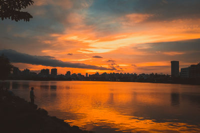 Scenic view of river against sky during sunset