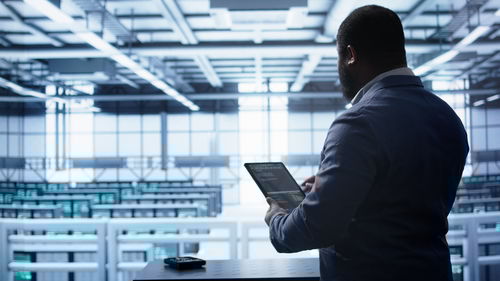 Side view of businessman using mobile phone