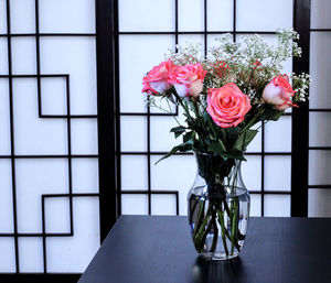 Close-up of roses in vase on table