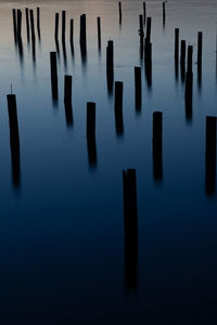 High angle view of wooden posts sea