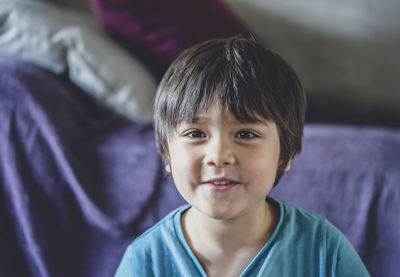 Close-up portrait of cute boy at home