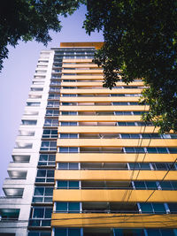 Low angle view of apartment building against sky