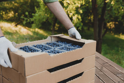 Low section of woman holding wooden box