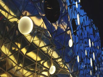 Low angle view of illuminated lights at night