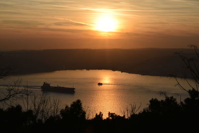 Scenic view of sea against orange sky