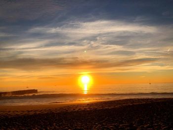 Scenic view of beach against sky during sunset