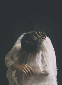 Woman with old white embroidered cloak iv