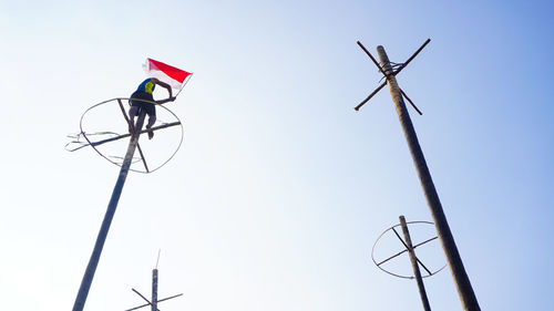 Low angle view of telephone pole against clear sky