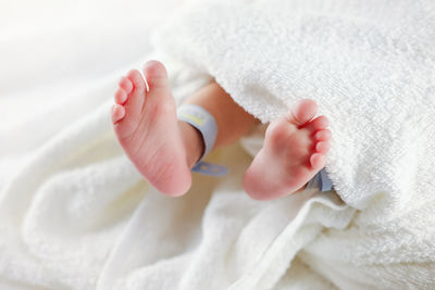 Close-up of baby feet on bed