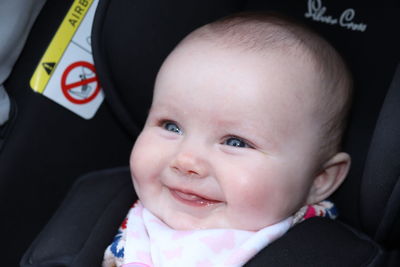 Portrait of cute baby girl in car