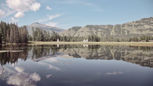 Scenic view of lake and mountains against sky