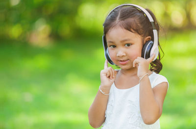 Portrait of cute girl standing outdoors