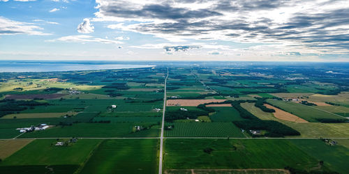 Summer day in rural portion of wisconsin with farmland and lake winnebago out in the distance