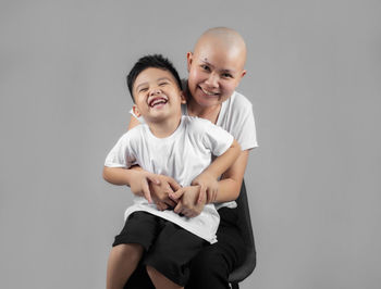 Portrait of smiling boy against white background