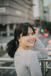 Portrait of smiling woman in city