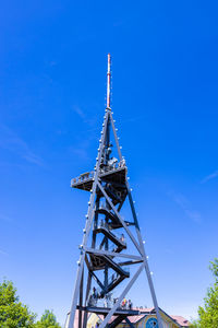 Low angle view of crane against blue sky