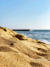 Scenic view of beach against clear sky