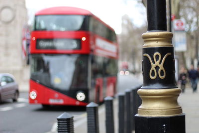 Close-up of pole on footpath in city