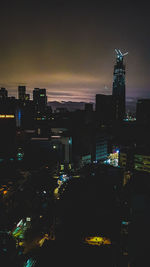 High angle view of illuminated buildings against sky at night