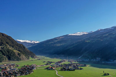 Scenic view of mountains against clear blue sky