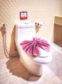 Close-up of pink flower on table in bathroom