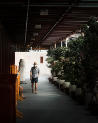 Rear view of woman walking in corridor