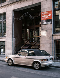Car on street against building in city