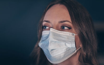 Beautiful woman wearing mask looking away