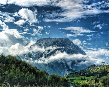 Scenic view of mountains against cloudy sky