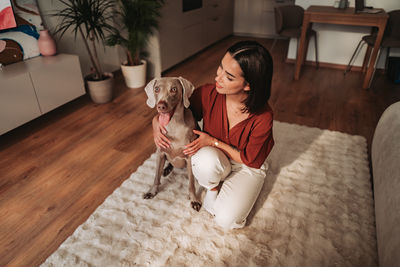 Portrait of dog sitting on floor at home