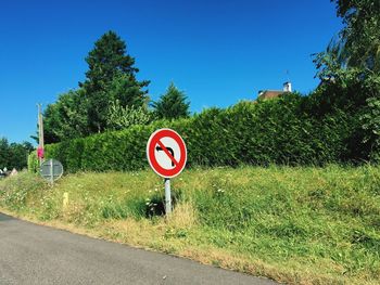 Road sign against blue sky