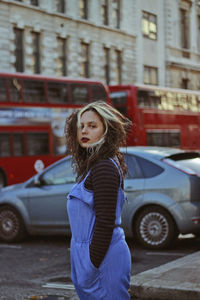 Young woman in car on street during winter