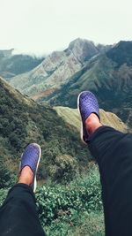 Low section of man standing on mountain