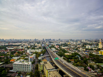 High angle view of street amidst buildings against sky