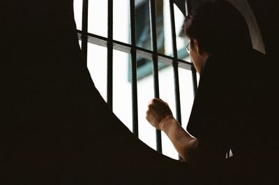 Woman looking through window