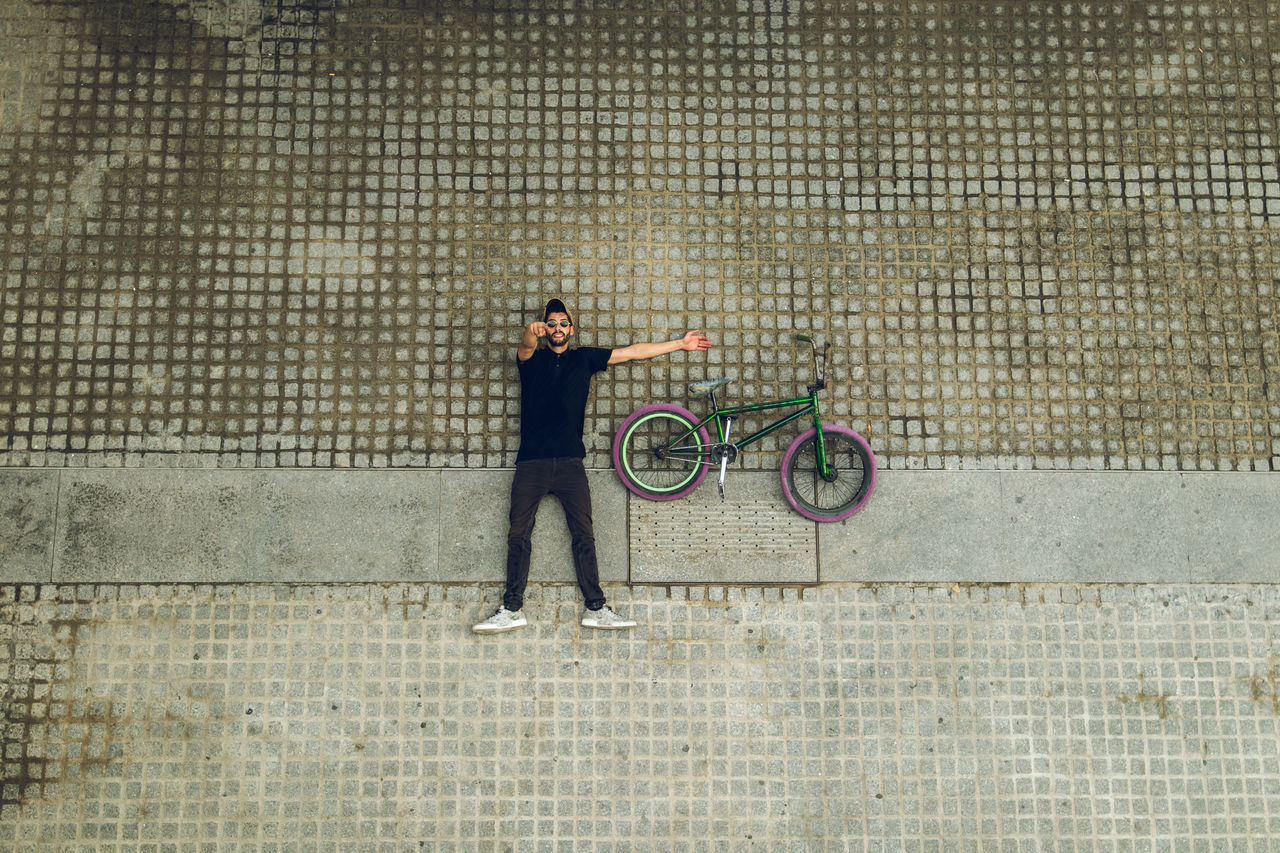 SIDE VIEW OF A WOMAN WITH BICYCLE