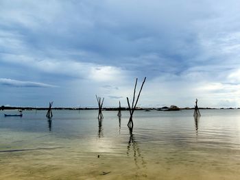 Scenic view of sea against cloudy sky