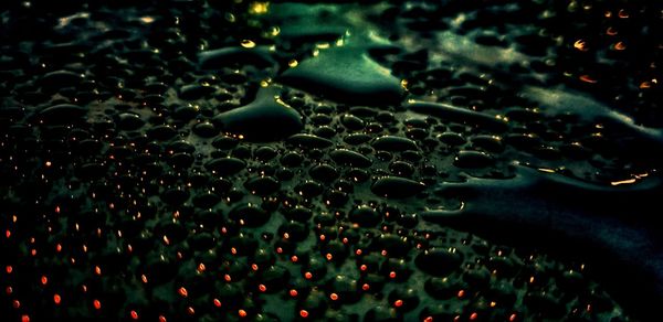 Full frame shot of raindrops on water