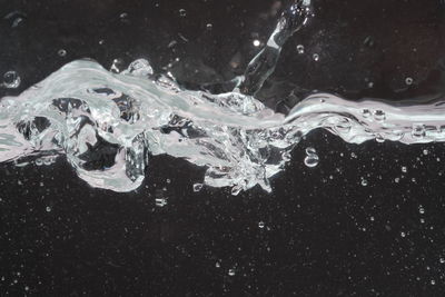 Close-up of splashing water against black background