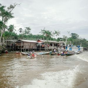 Boats in river against sky