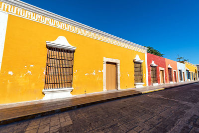 Yellow built structure against clear blue sky