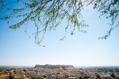 Aerial view of city against clear blue sky